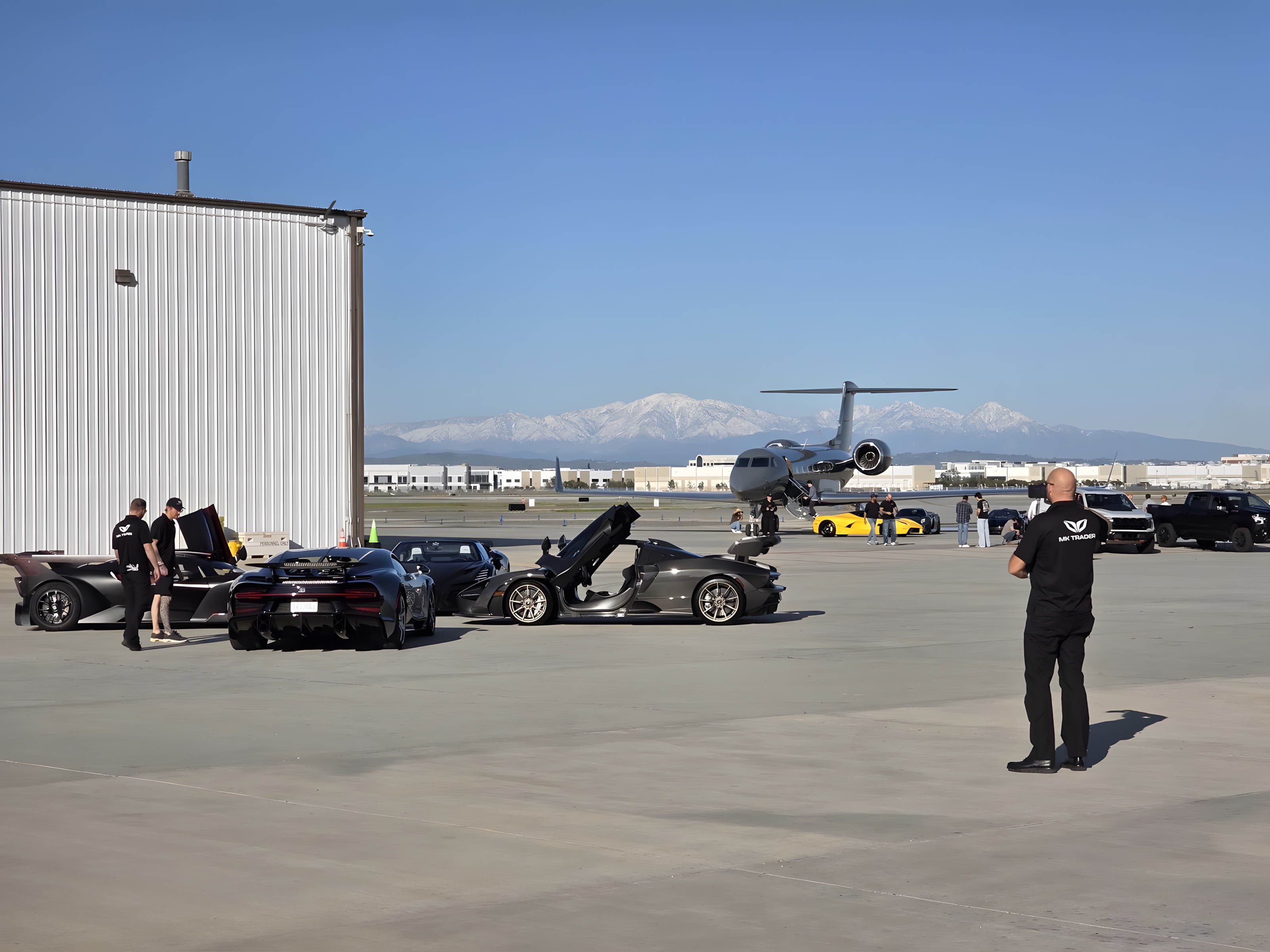Hypercars at private airfield with jet